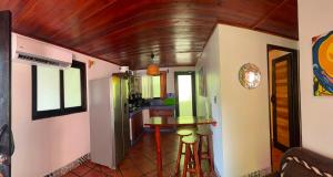 a kitchen with a table and stool in a room at Locanda Samara Beach in Sámara
