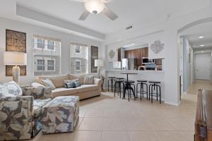 a living room with a couch and chairs and a kitchen at White Cap Condo B201 by Sun Palace Vacations in Fort Myers Beach +39 photos