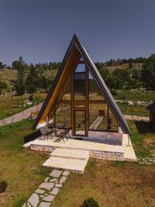 a small cabin with a pitched roof on a field at Sunrise House in Plužine +28 photos