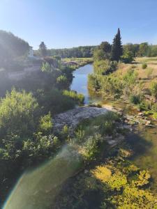 an aerial view of a river with a rainbow at Cozy studio - proche Cité de Carcassonne in Couffoulens
