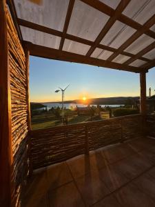 a view of the sunset from the balcony of a house at Casa Quento in Castro