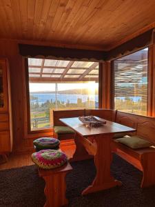 a wooden room with a table and a window at Casa Quento in Castro