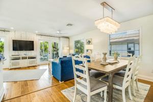 a dining room with a table and a blue couch at Sandy's Getaway in Anna Maria
