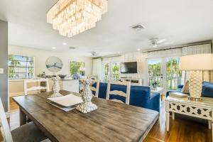a dining room and living room with a wooden table at Sandy's Getaway in Anna Maria
