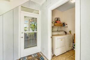 a kitchen with a door leading to a laundry room at Sandy's Getaway in Anna Maria