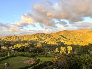 a view of a valley with mountains and trees at Posada del Quindío 0219 in Armenia