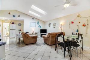a living room with a couch and a table and chairs at Bella Villa in Bradenton