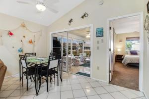 a dining room and living room with a table and chairs at Bella Villa in Bradenton