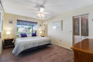 a bedroom with a bed and a ceiling fan at Bella Villa in Bradenton +30 photos