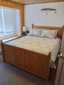 a bedroom with a bed with a wooden frame and a window at Back Bay Getaway in Hayward +19 photos