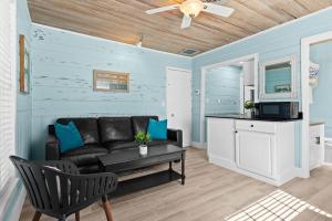 a living room with a couch and a table at Parrot Beach Cottages Suite #4 in Siesta Key