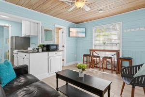 a living room with a couch and a table at Parrot Beach Cottages Suite #4 in Siesta Key