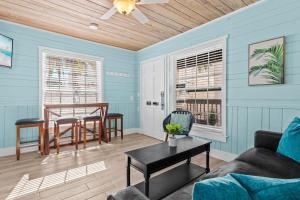 a living room with a couch and a table at Parrot Beach Cottages Suite #4 in Siesta Key