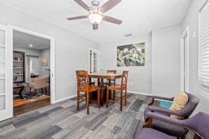 a living room with a dining room table and chairs at Don't Be Koi in Bradenton