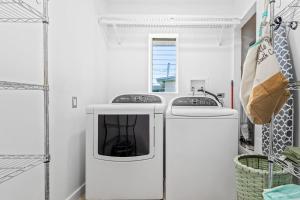a white laundry room with a washer and dryer at Don't Be Koi in Bradenton +13 photos