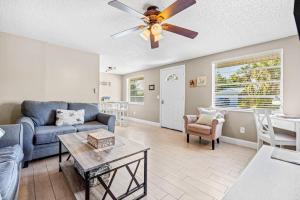 a living room with a couch and a ceiling fan at Holmes Beach Bungalow - B in Holmes Beach