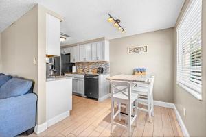a kitchen with a table and chairs in a room at Holmes Beach Bungalow - B in Holmes Beach +39 photos