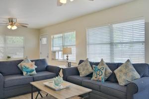 a living room with blue couches and a table at Bungalow A in Bradenton Beach