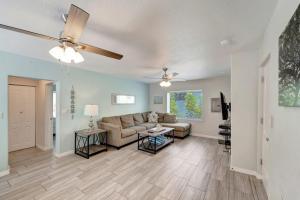 a living room with a couch and a ceiling fan at Bungalow B in Bradenton Beach