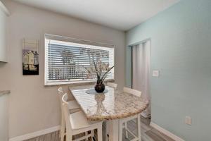 a dining room with a table and chairs and a window at Bungalow B in Bradenton Beach