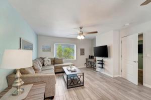 a living room with a couch and a tv at Bungalow B in Bradenton Beach