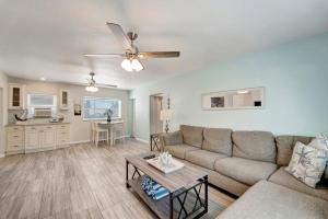 a living room with a couch and a table at Bungalow B in Bradenton Beach