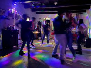 a group of people dancing on a dance floor at Görbeút Vendégház in Vigántpetend