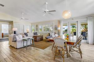 a large living room with a table and chairs at Sundance Cottage in Anna Maria