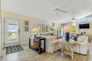 a living room with a couch and a table at Sundance Cottage in Anna Maria