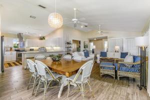 a kitchen and living room with a wooden table and chairs at Sundance Cottage in Anna Maria