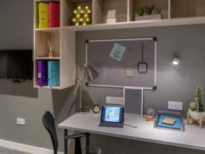a desk with a laptop computer on top of it at ABeleven in Aberdeen