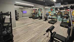 a gym with treadmills and machines in a room at ABeleven in Aberdeen