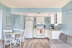 a living room with a couch and a table and a kitchen at Bungalow W in Bradenton Beach