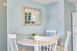 a dining room with a table and chairs and a mirror at Bungalow W in Bradenton Beach +24 photos