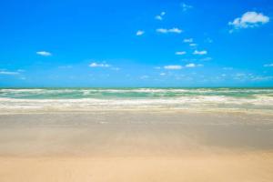 a sandy beach with the ocean in the background at Holmes Beach Bungalow - A in Holmes Beach