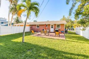 a house with a palm tree in the yard at Holmes Beach Bungalow - A in Holmes Beach
