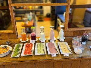 a table topped with different types of food and vases at Hotel Sol Natura in Ollantaytambo