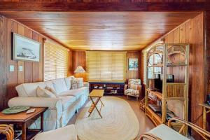 a living room with a couch and a table at The Wee Cottage in Anna Maria