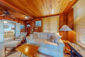a living room with a couch and a table at The Wee Cottage in Anna Maria