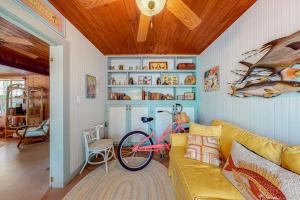 a bike parked in a living room with a couch at The Wee Cottage in Anna Maria +18 photos