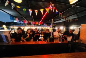 a group of people standing at a bar at 1900 Backpacker's Hostel in Lima