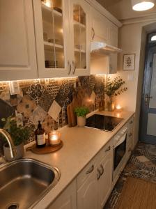 a kitchen with white cabinets and a sink at Levendula udvarház in Sopron