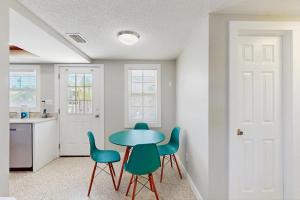 a kitchen with a table and four chairs at Pineapple House in Holmes Beach