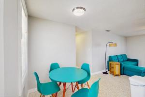 a room with a table and chairs and a couch at Pineapple House in Holmes Beach