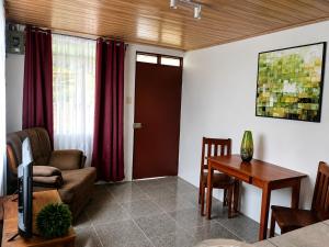 a living room with a couch and a table at Arenal Rental CASA PALMERA UNO in Arenal +7 photos