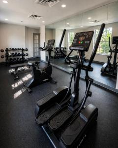a gym with several treadmills and exercise bikes at MainStay Suites Columbia Harbison in Harbison