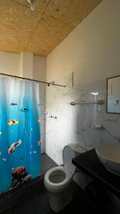 a bathroom with a toilet and a shower curtain with fish at Balcon de Gocta in Cocachimba +68 photos