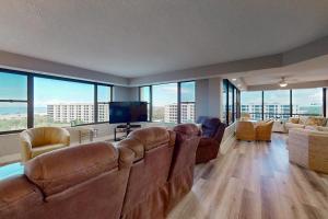 a large living room with leather furniture and large windows at The Aquarium in Sarasota +86 photos