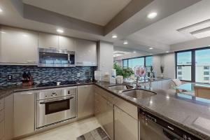 a large kitchen with a sink and a stove at The Aquarium in Sarasota