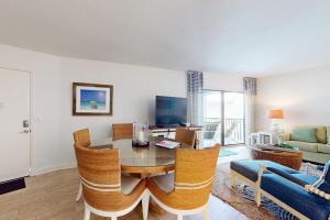 a living room with a table and chairs and a couch at Gulf Place 20 in Holmes Beach